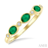 4X3 MM Oval Shape Emerald and 1/20 Ctw Bezel Set Round Cut Diamond Precious Fashion Band in 10K Yellow Gold