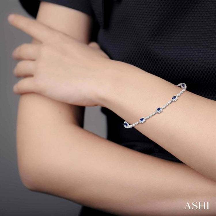 5x3 MM Oval Cut Sapphire and 1/20 Ctw Round Cut Diamond Bracelet in 14K White Gold